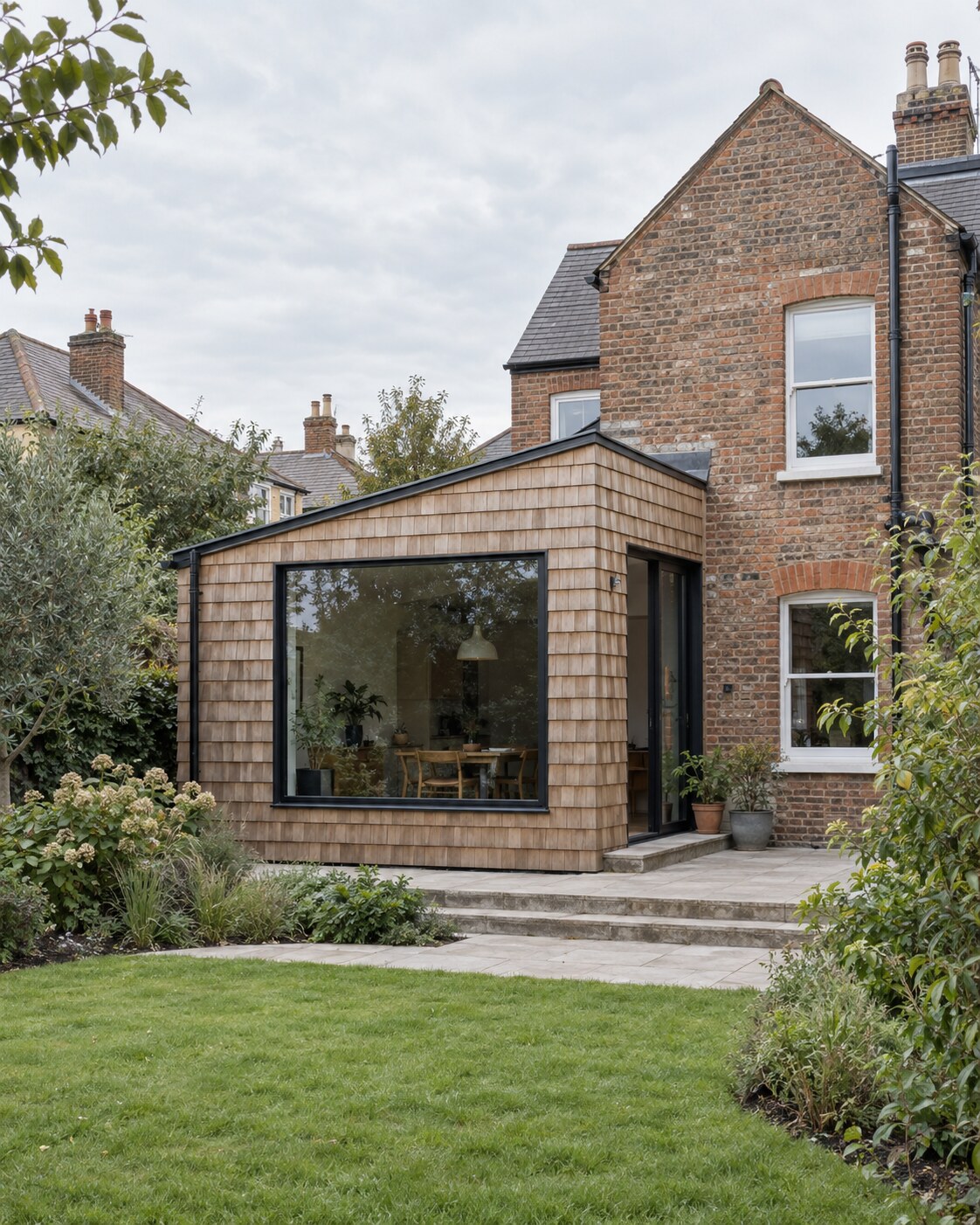 Timber-clad contemporary extension to a period brick house